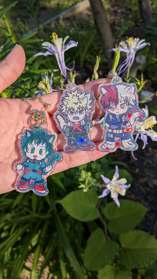 Holographic acrylic keychains of The Origin Trio from My Hero Academia held in a hand