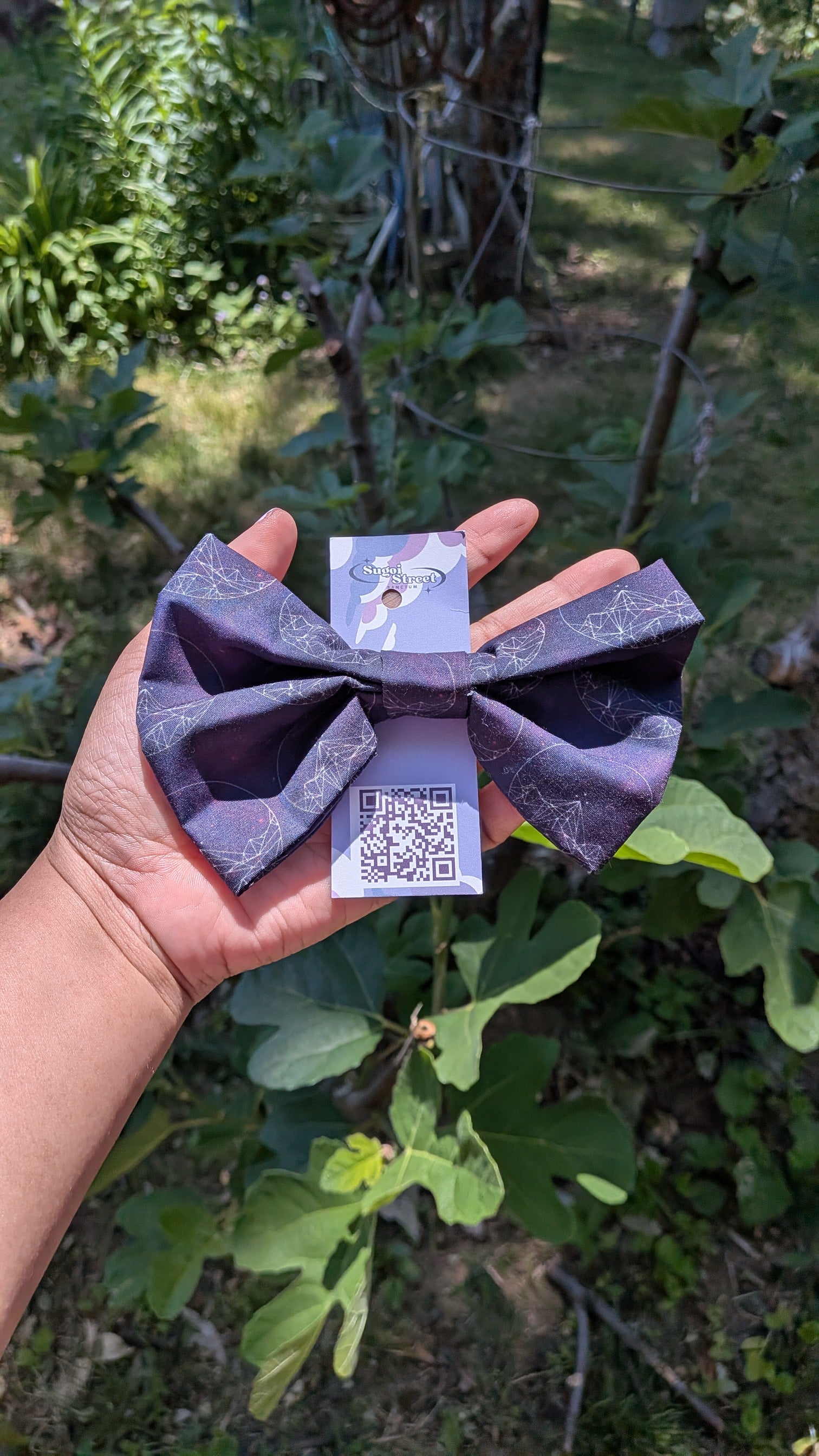 Hand holding a purple origami-style product