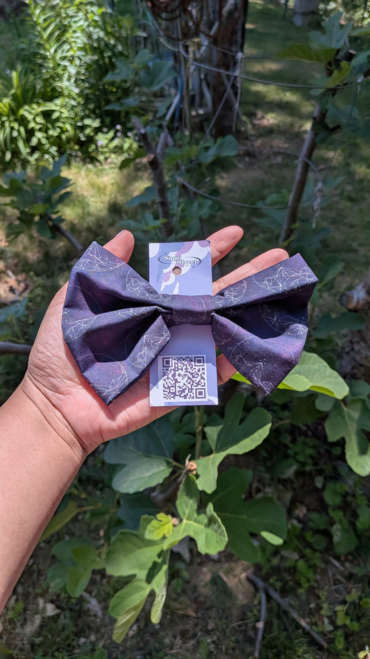 Hand holding a purple origami-style product